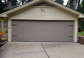 Inside view of the garage before carriage-style door installation—old door and tracks, Davis, CA