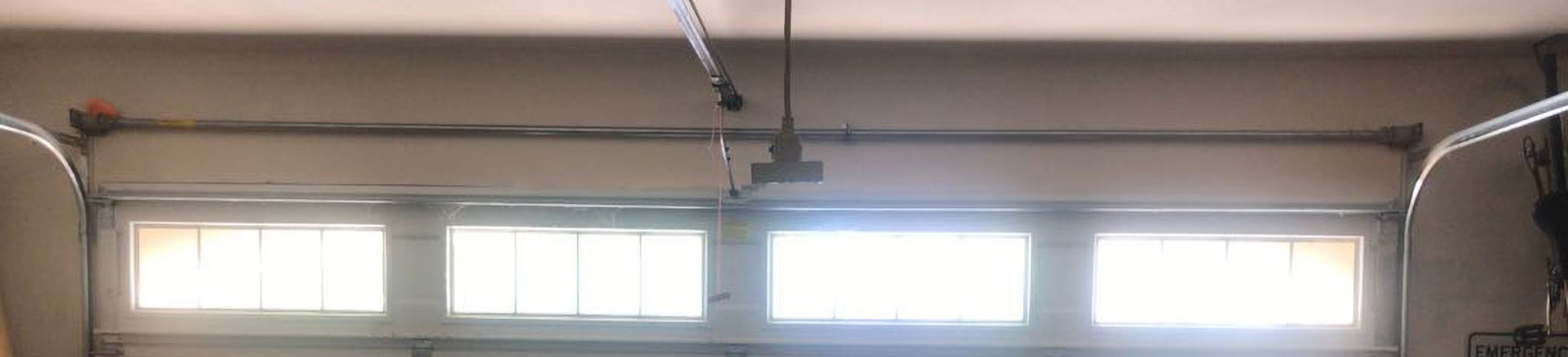 Inside view showing heavy-duty steel garage door tracks and newly installed lifting cables in Dixon, CA home garage