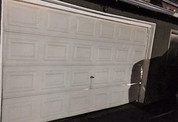Interior photo showing a freshly installed insulated sectional garage door with white panel design in Davis, CA